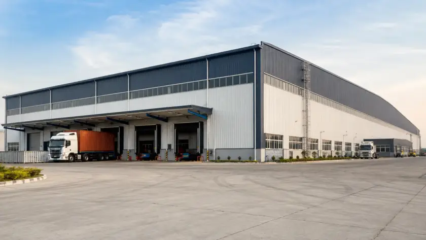Modern PEB warehouse with clear-span steel structure and loading bays